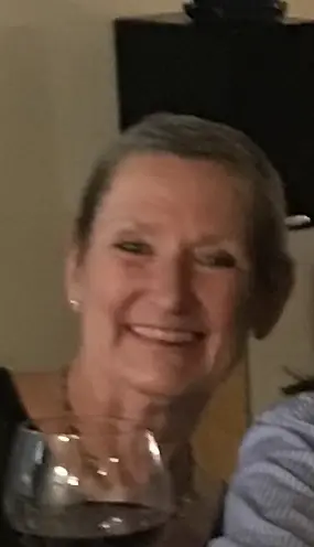 Smiling older woman with short hair in a close-up portrait.