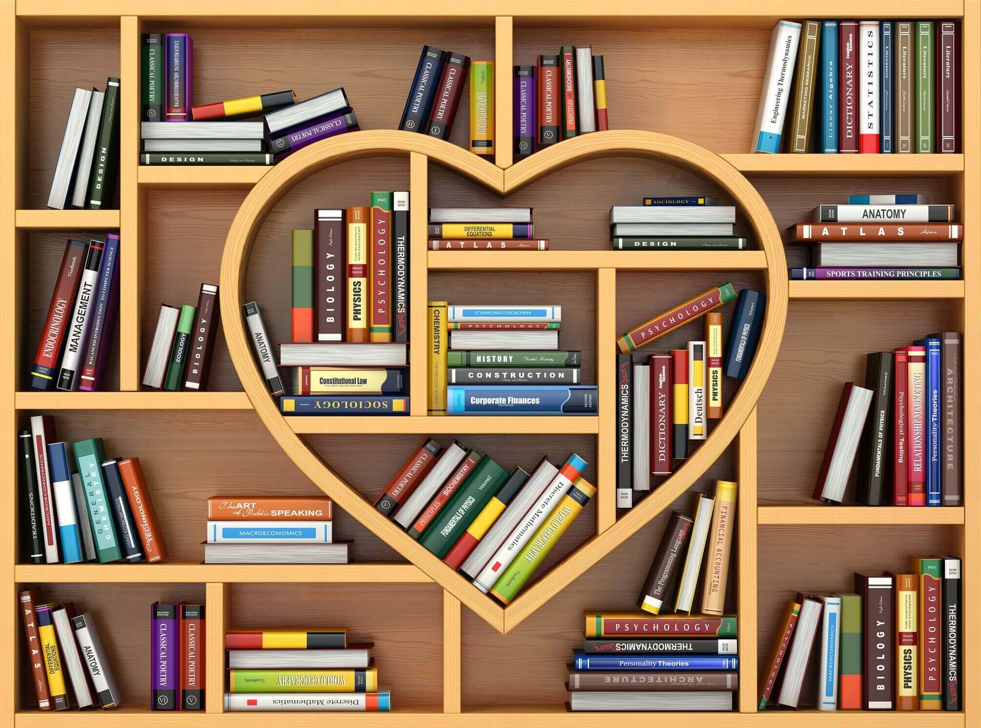 Heart-shaped wooden bookshelf filled with colorful books.